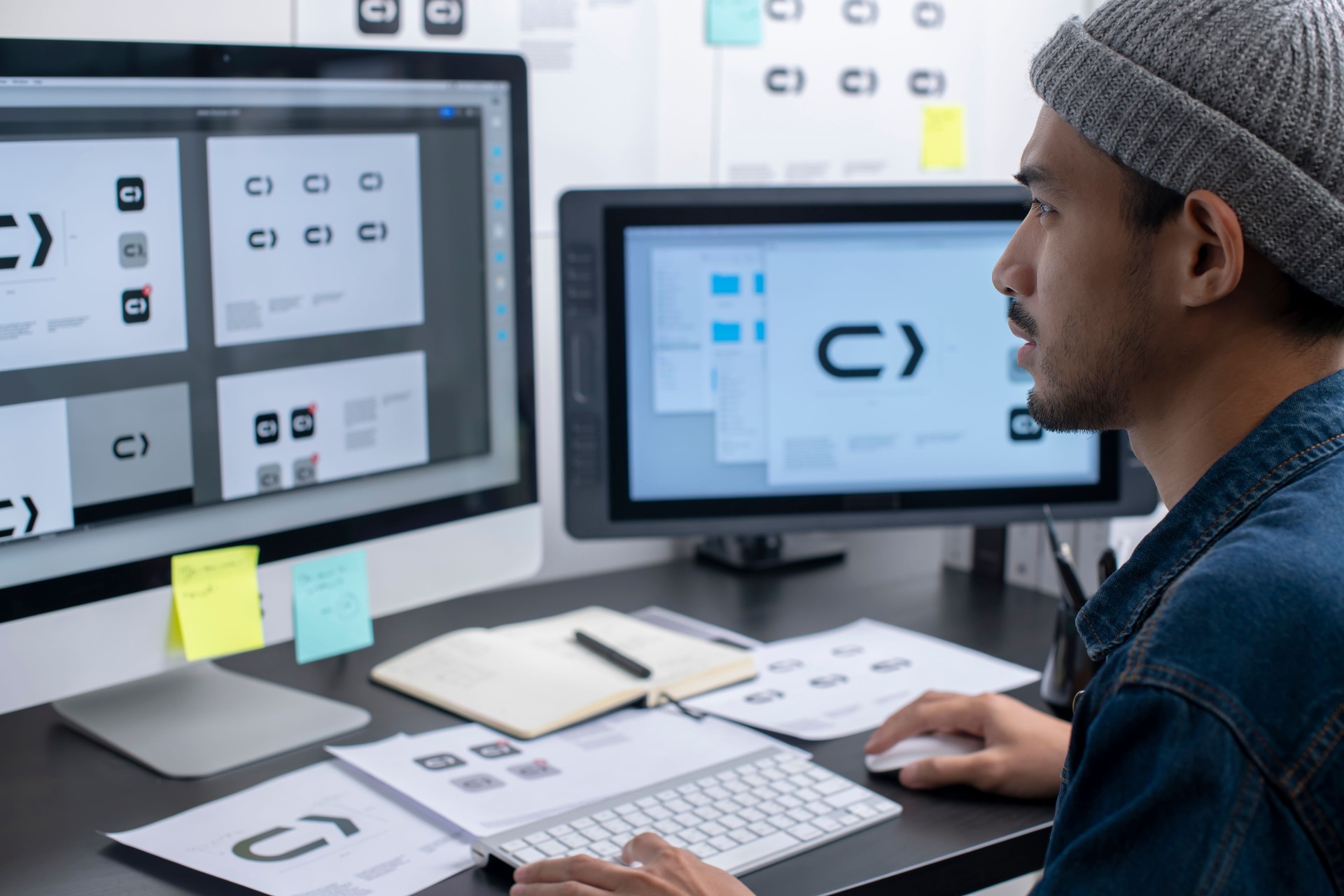 Young Asian man graphic designer working in his studio office.